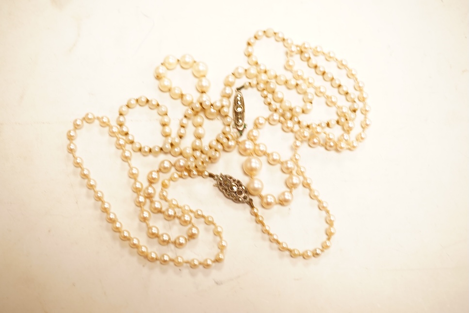 Two single strands graduated cultured pearl necklaces, both with marcasite set sterling clasps, longest, 64cm.
